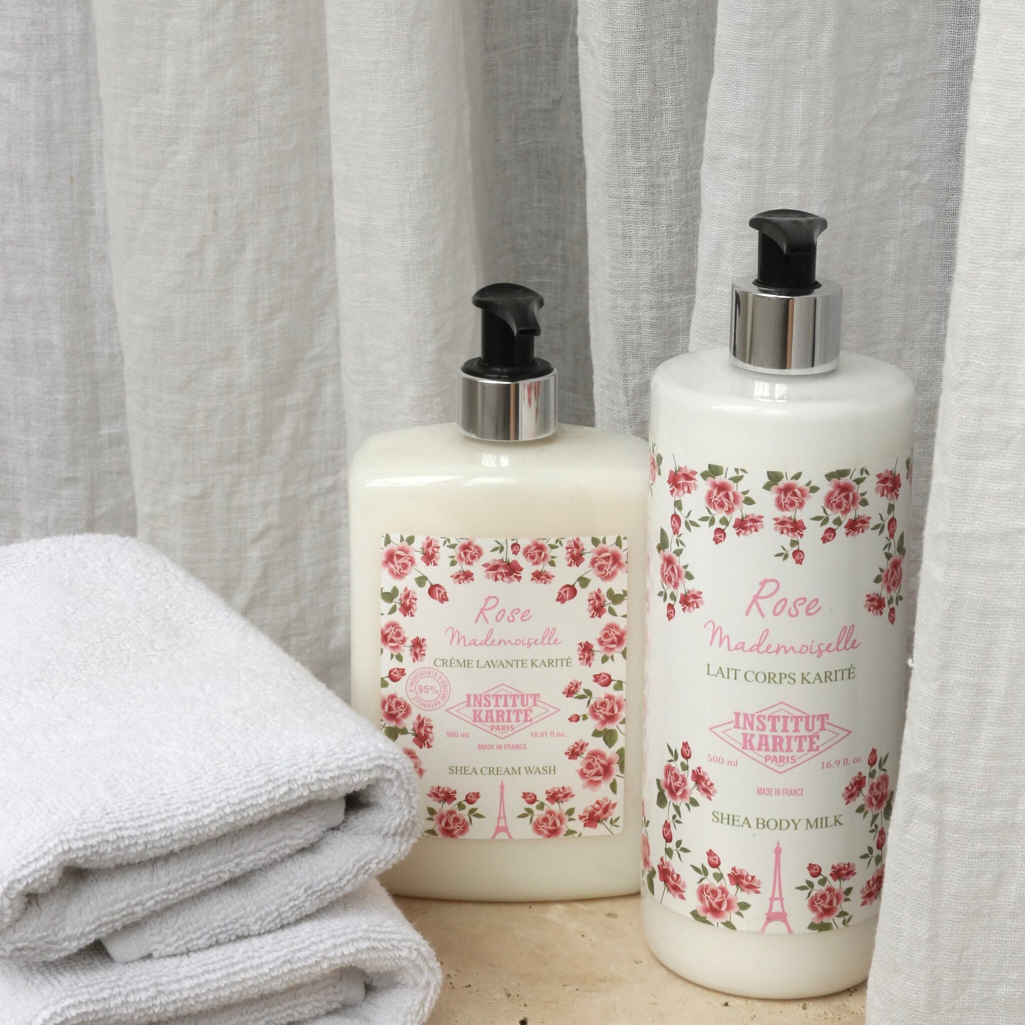 Rose Mademoiselle Shea Cream Wash 500ml beside Rose Mademoiselle Shea Body Milk with folded towels