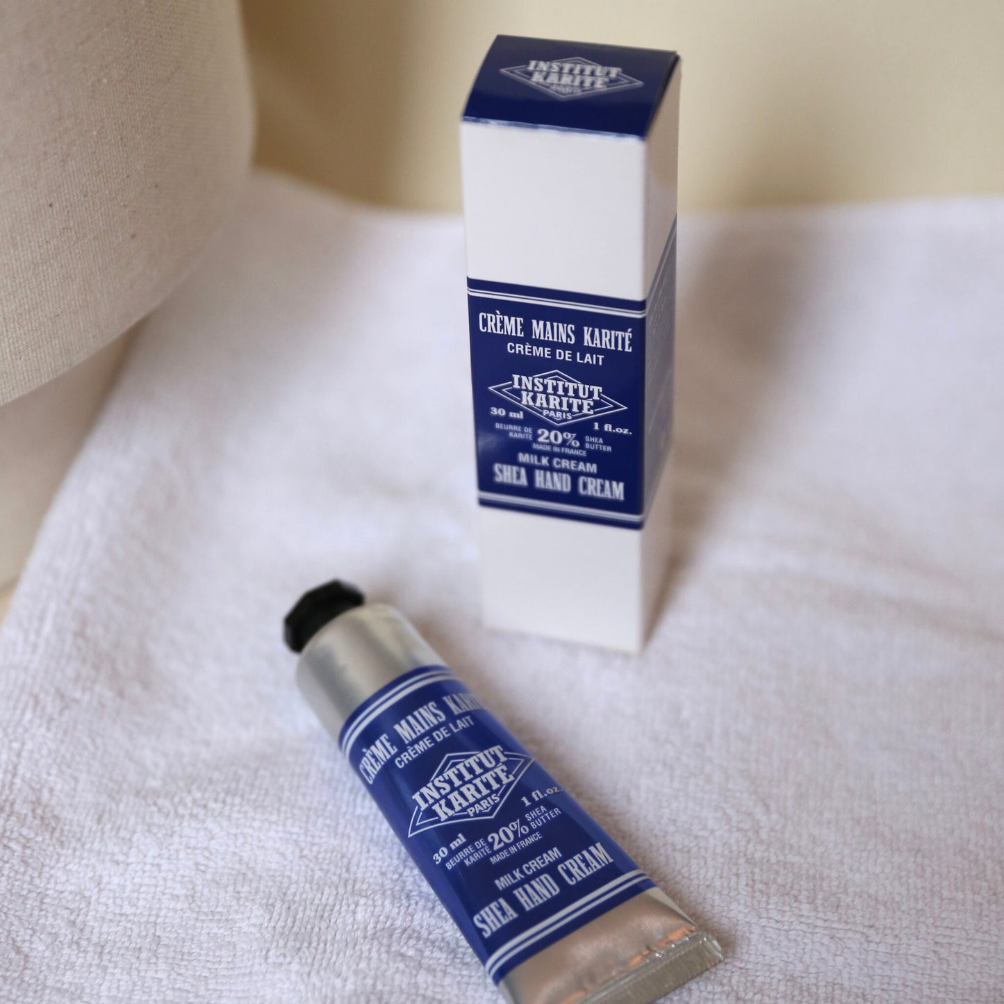 Shea Hand Cream Milk Cream 30ml tube with its gift box on a white towel