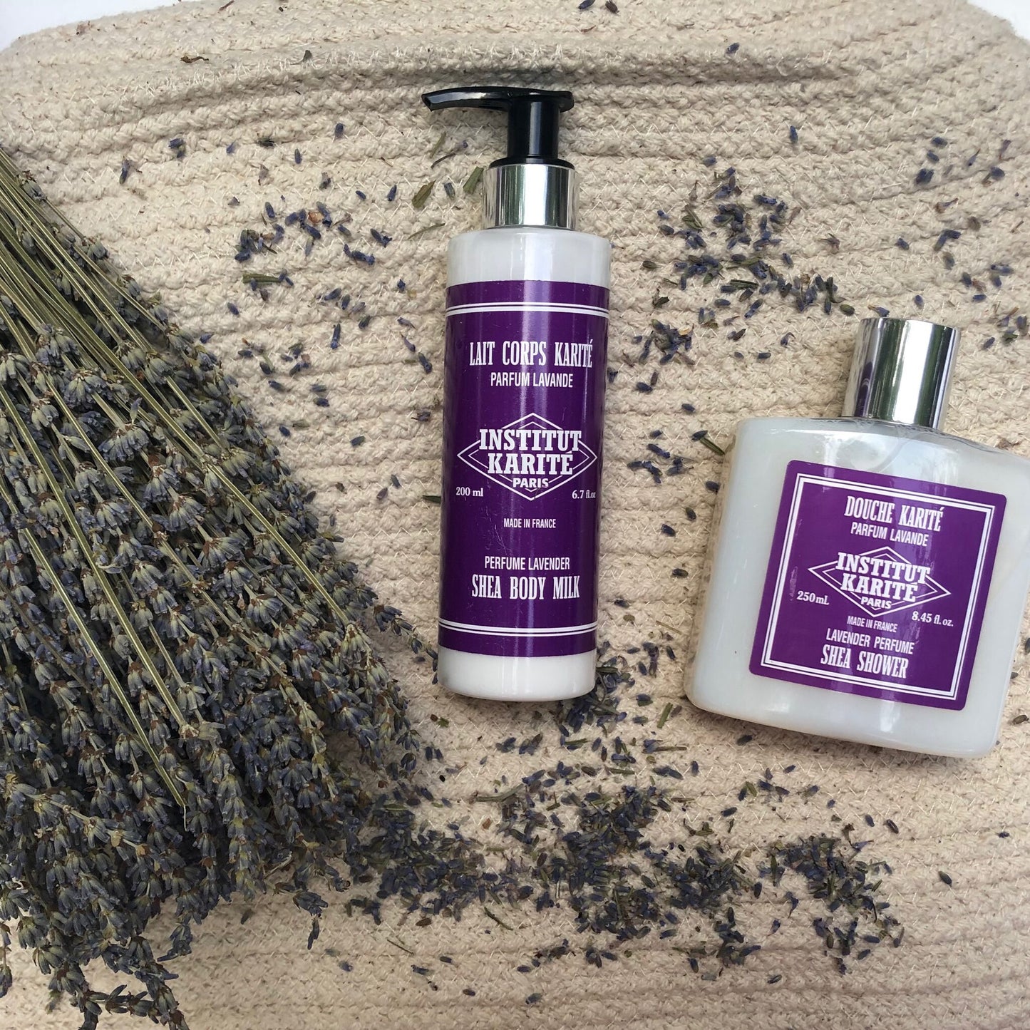 200mL Lavender Shea Body Milk and Shea Shower gel by Institut Karité Paris beside a bundle of dried lavender